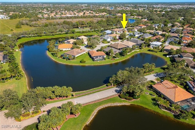 drone / aerial view with a residential view and a water view