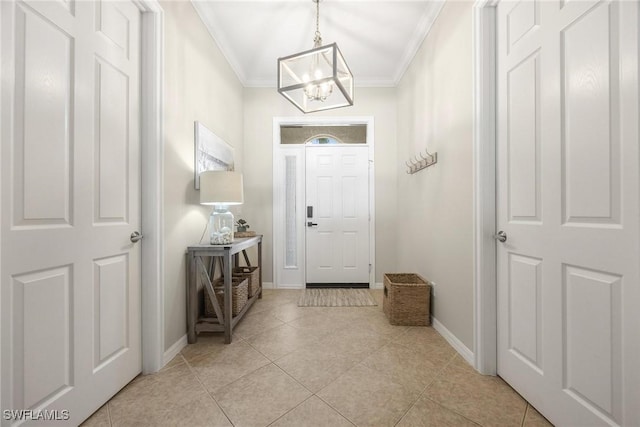 interior space with an inviting chandelier, baseboards, light tile patterned floors, and ornamental molding