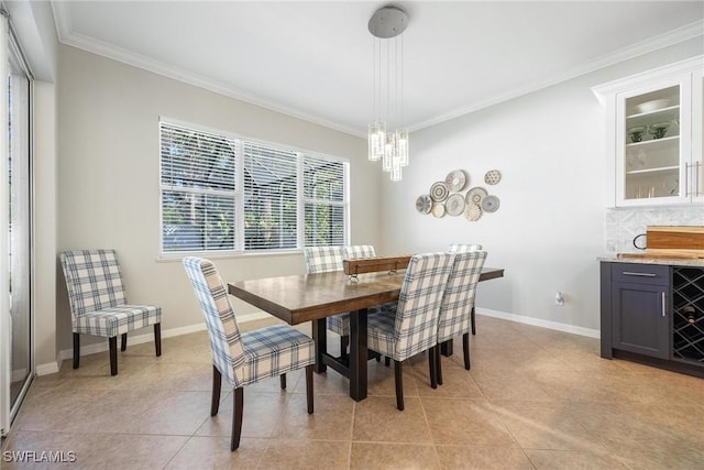 dining space featuring light tile patterned floors, baseboards, a chandelier, and crown molding