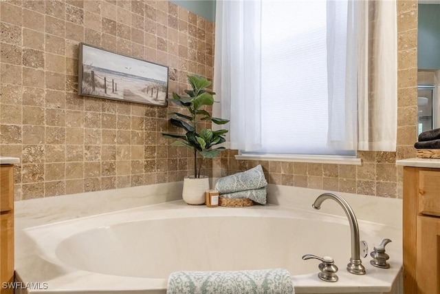 bathroom with a bath and vanity