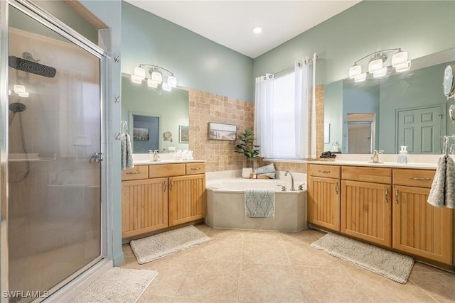 bathroom with a sink, two vanities, a shower stall, and a garden tub