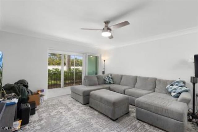 living room with carpet floors, ceiling fan, and ornamental molding