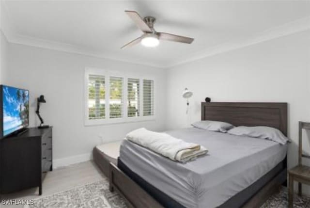 bedroom featuring ornamental molding, baseboards, and a ceiling fan