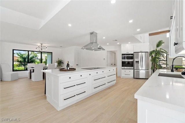 kitchen with a center island, stainless steel appliances, white cabinetry, a sink, and island range hood