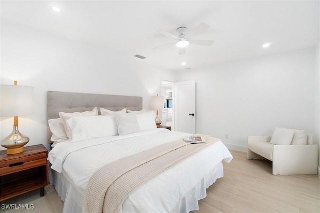 bedroom with light wood-type flooring, visible vents, and recessed lighting