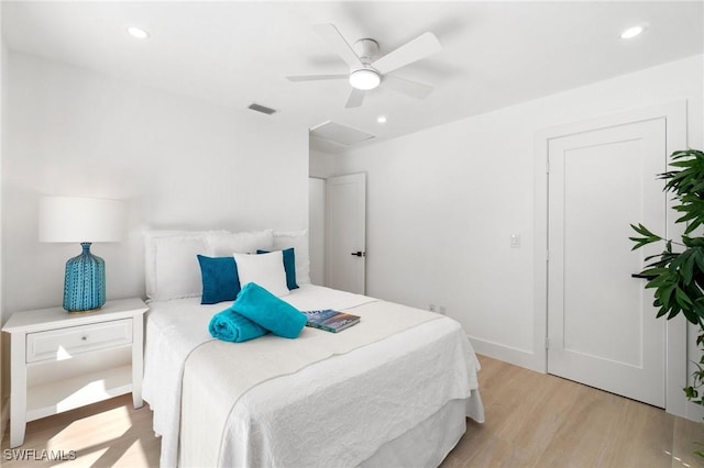 bedroom with attic access, recessed lighting, visible vents, and light wood-style floors