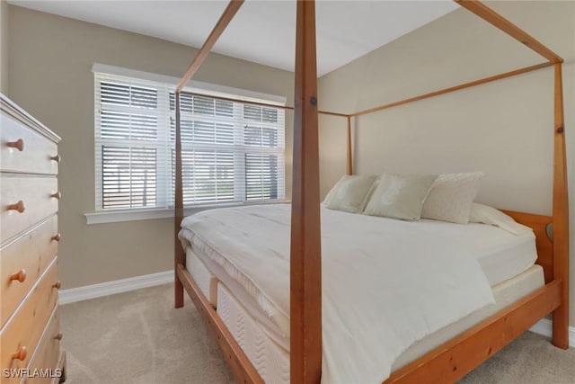 bedroom featuring baseboards and light colored carpet