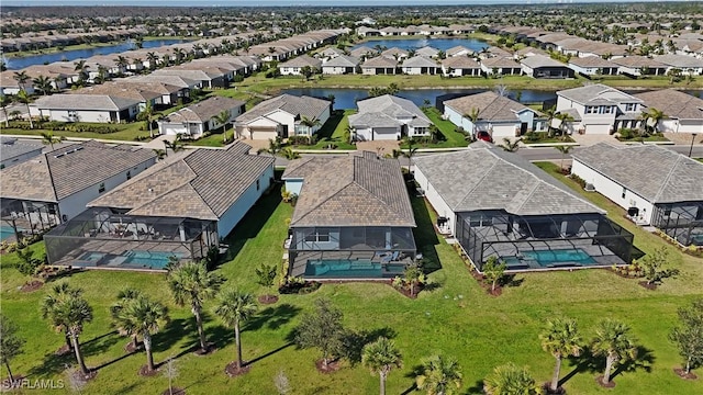 drone / aerial view with a water view and a residential view