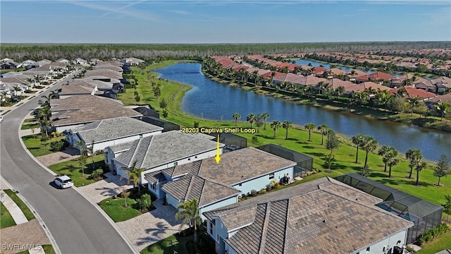 birds eye view of property featuring a water view and a residential view