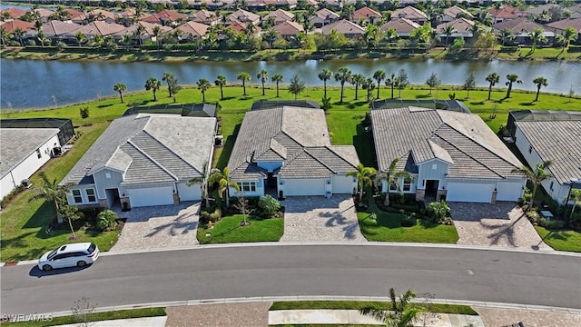 drone / aerial view with a water view and a residential view