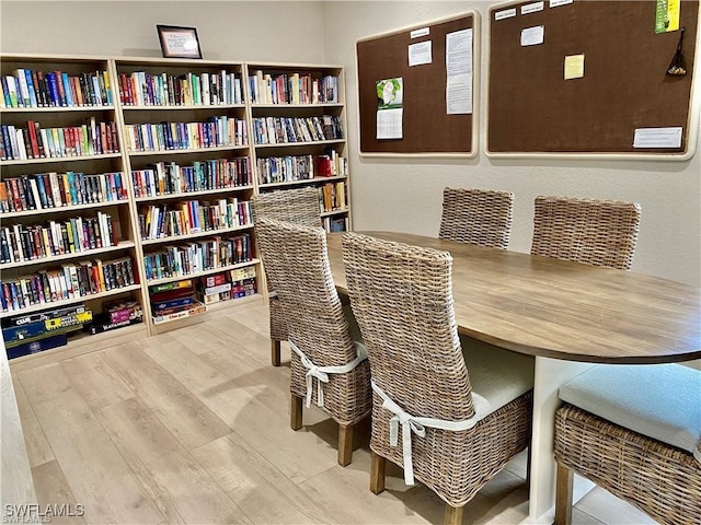 dining space with wood finished floors