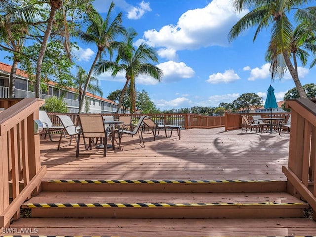 wooden terrace with outdoor dining area