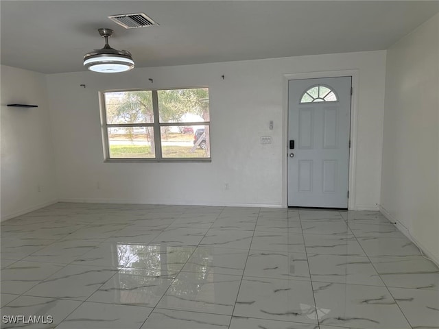 entryway with marble finish floor, visible vents, and baseboards