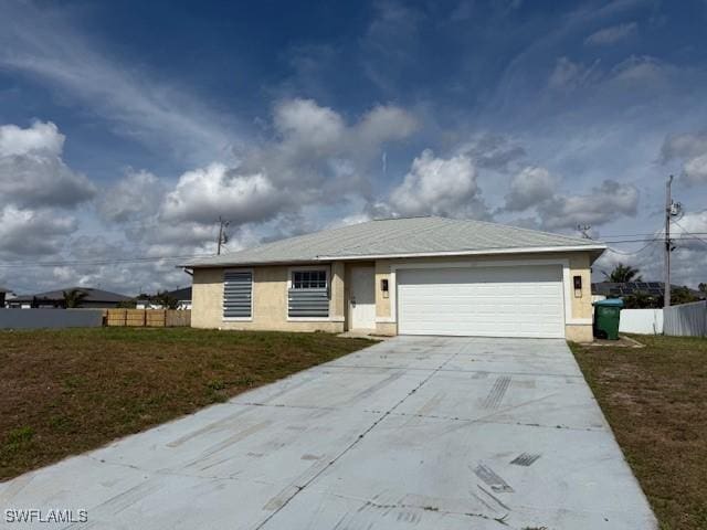 ranch-style home with stucco siding, a front yard, fence, a garage, and driveway