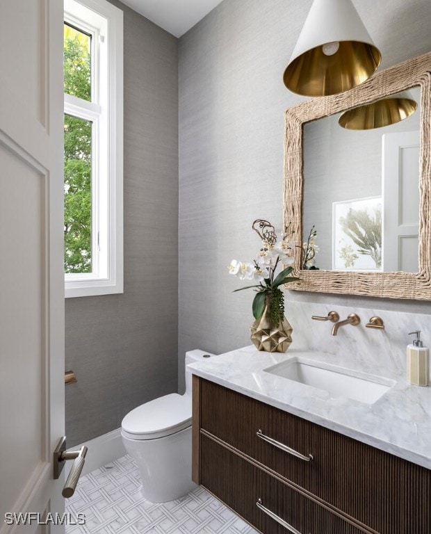 bathroom featuring toilet, tile patterned flooring, and vanity