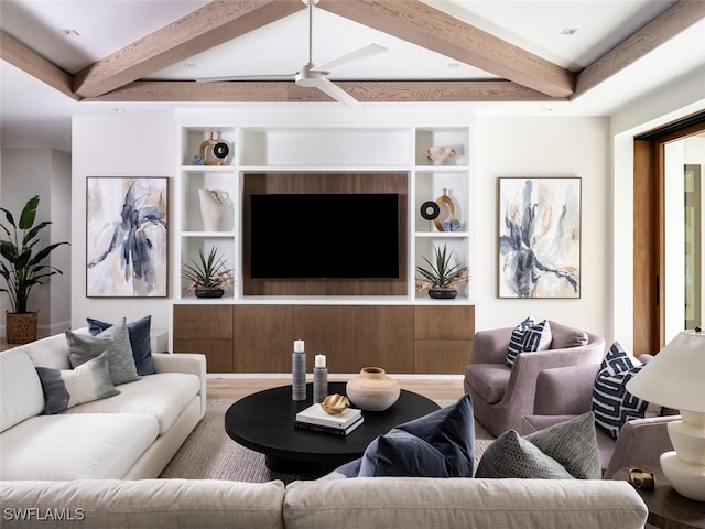 living area featuring built in features, beamed ceiling, ceiling fan, and wood finished floors