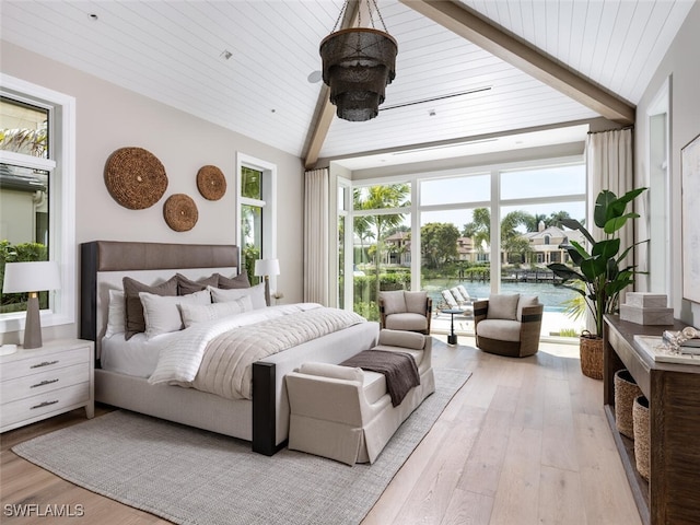 bedroom featuring wooden ceiling, a water view, vaulted ceiling with beams, and light wood finished floors