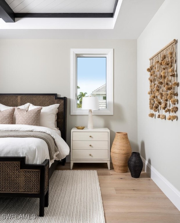 bedroom with light wood-style floors and baseboards