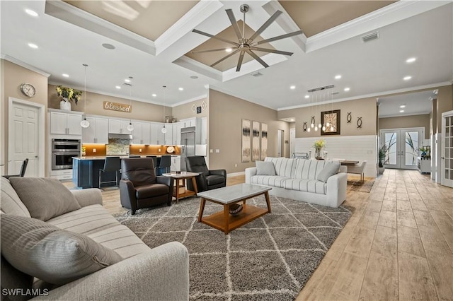 living area with crown molding, coffered ceiling, wood finished floors, and french doors