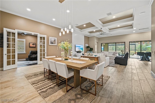 dining area featuring light wood finished floors, coffered ceiling, and french doors