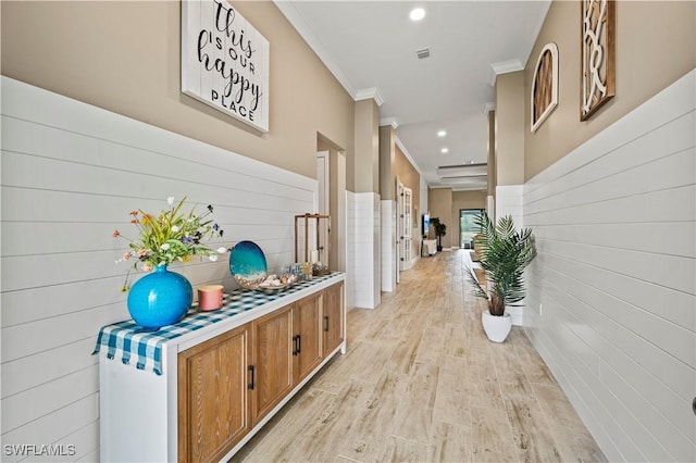 hall with light wood-style flooring, visible vents, crown molding, and recessed lighting