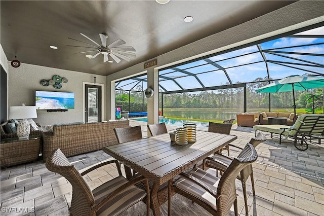 view of patio featuring glass enclosure, outdoor lounge area, and a ceiling fan