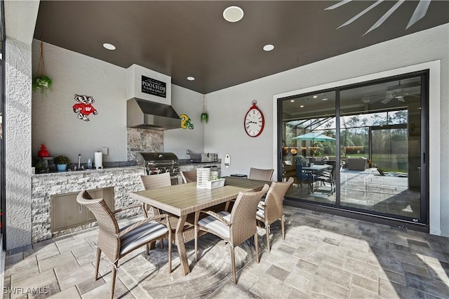 dining area with a sunroom, recessed lighting, stone finish floor, and ceiling fan