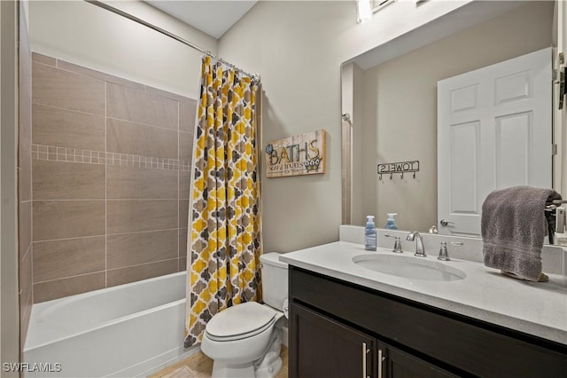 bathroom featuring toilet, shower / bath combo with shower curtain, and vanity