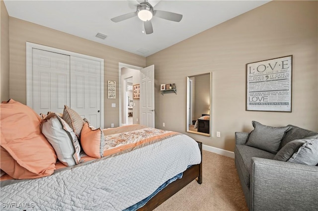 carpeted bedroom featuring baseboards, visible vents, a ceiling fan, lofted ceiling, and a closet