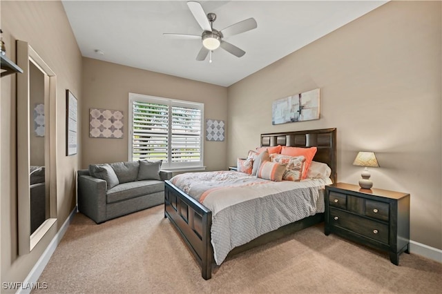 bedroom featuring light carpet, ceiling fan, and baseboards