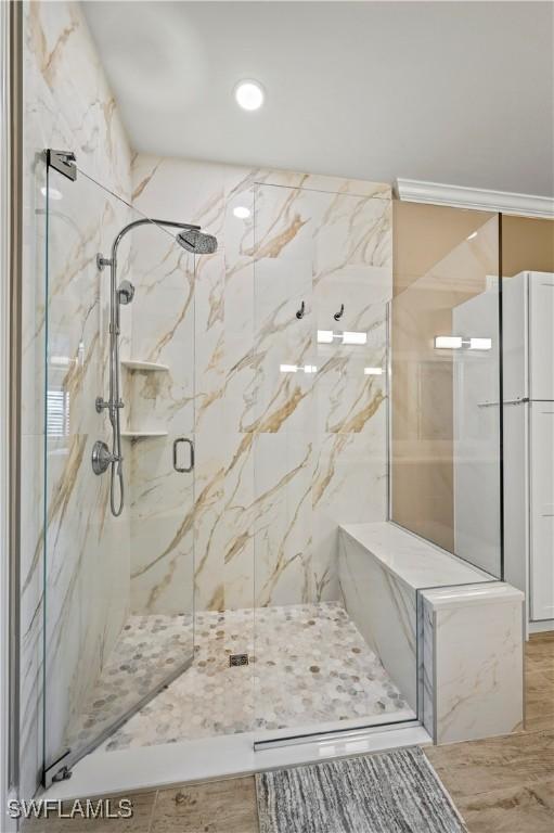 full bath featuring a marble finish shower