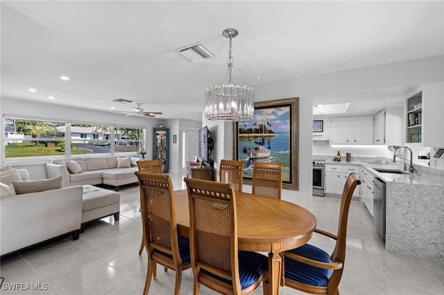 dining space featuring light tile patterned floors, ceiling fan with notable chandelier, visible vents, and recessed lighting