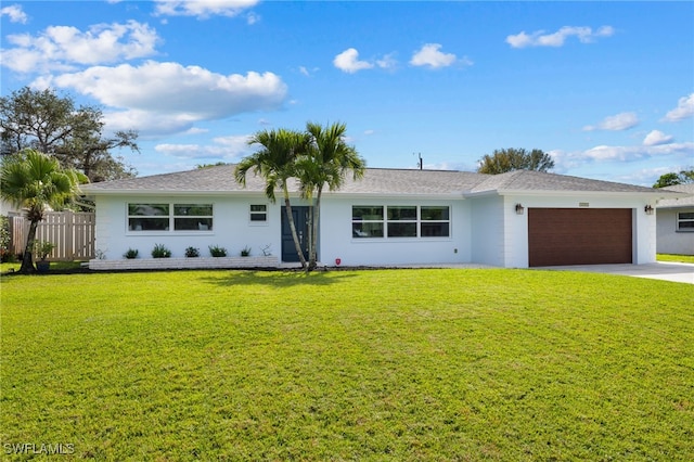 ranch-style house featuring a garage, driveway, a front lawn, and stucco siding