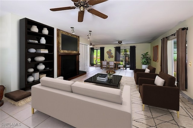 living area featuring a large fireplace and light tile patterned floors