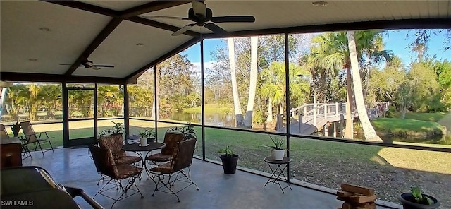 unfurnished sunroom featuring a ceiling fan