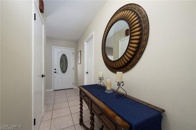 entryway featuring light tile patterned flooring and baseboards