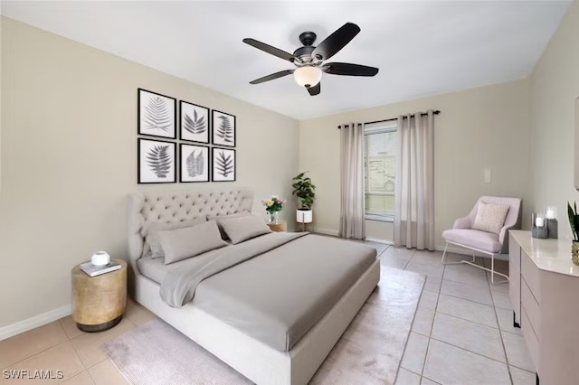 bedroom featuring a ceiling fan, light tile patterned flooring, and baseboards