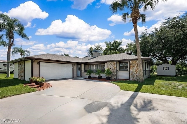 single story home featuring driveway, stone siding, a chimney, an attached garage, and a front lawn