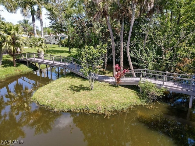 dock area with a yard and a water view