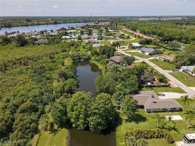 birds eye view of property featuring a water view and a residential view