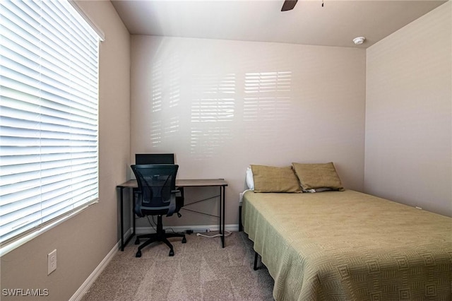 bedroom featuring light carpet, ceiling fan, and baseboards