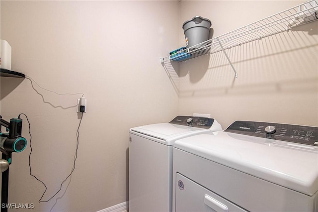 laundry area featuring laundry area, baseboards, and separate washer and dryer