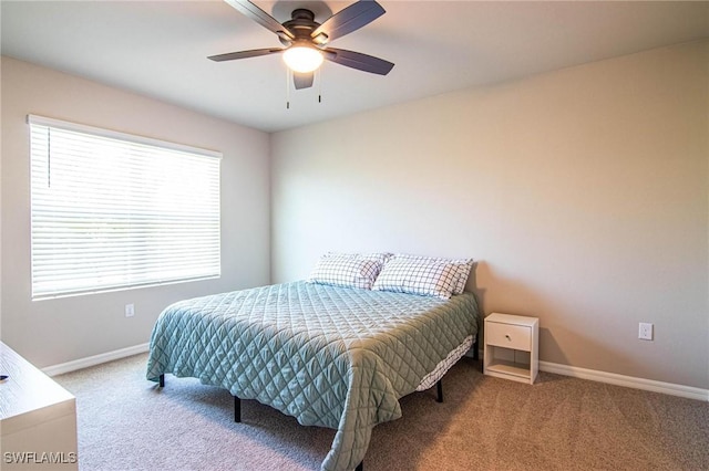 carpeted bedroom with a ceiling fan and baseboards