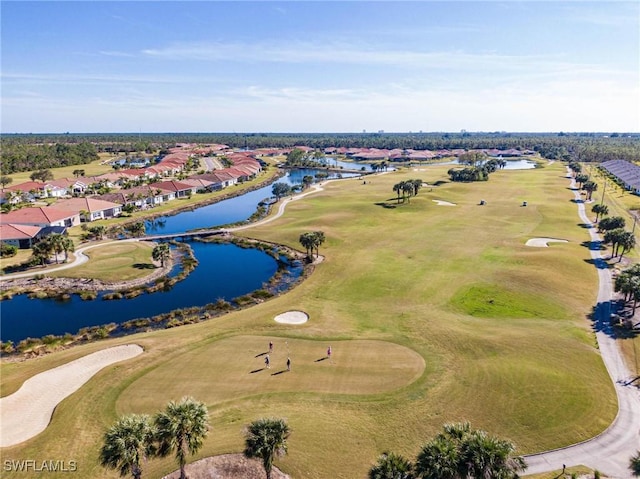 birds eye view of property with view of golf course, a water view, and a residential view