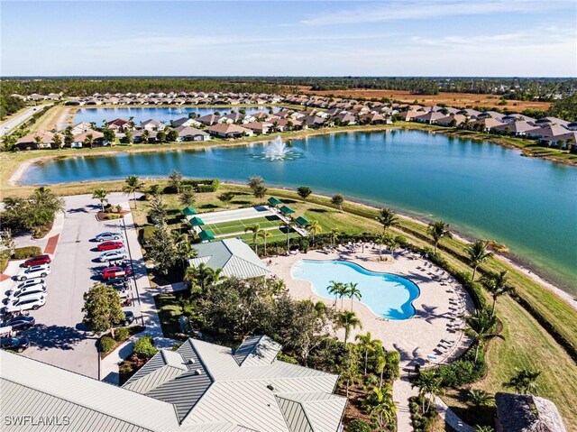 birds eye view of property with a water view and a residential view