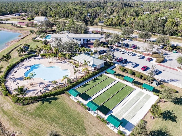 drone / aerial view with a water view and a wooded view