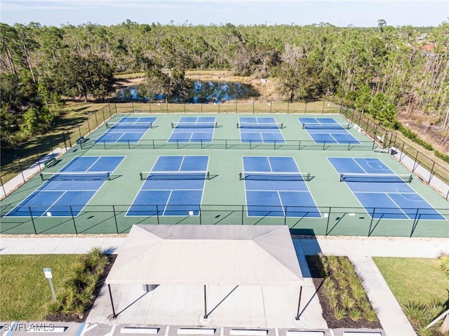 birds eye view of property featuring a water view and a forest view