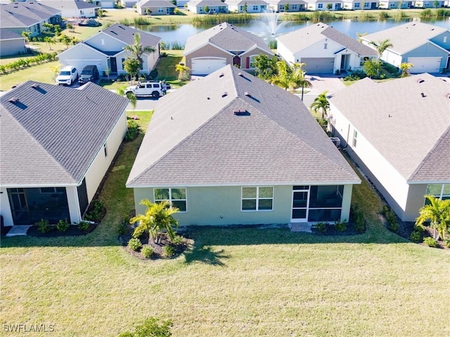 bird's eye view with a water view and a residential view