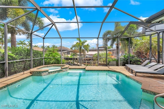 view of swimming pool with a patio, a lanai, and a pool with connected hot tub