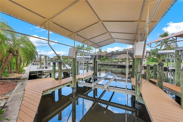 view of dock featuring a water view and boat lift